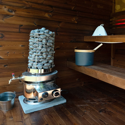 Titan SL1 with water tank in an outdoor wood sauna