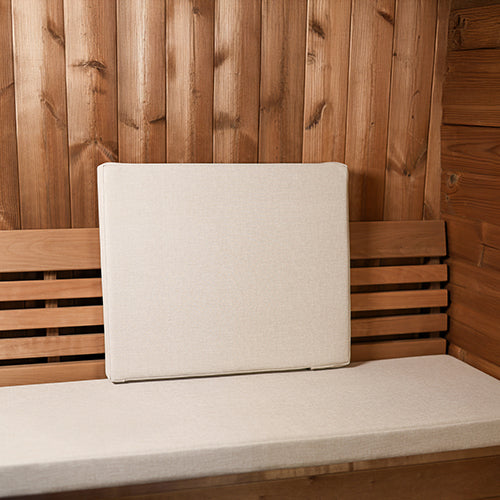Beige linen sauna backrest cushion resting on a wooden sauna bench